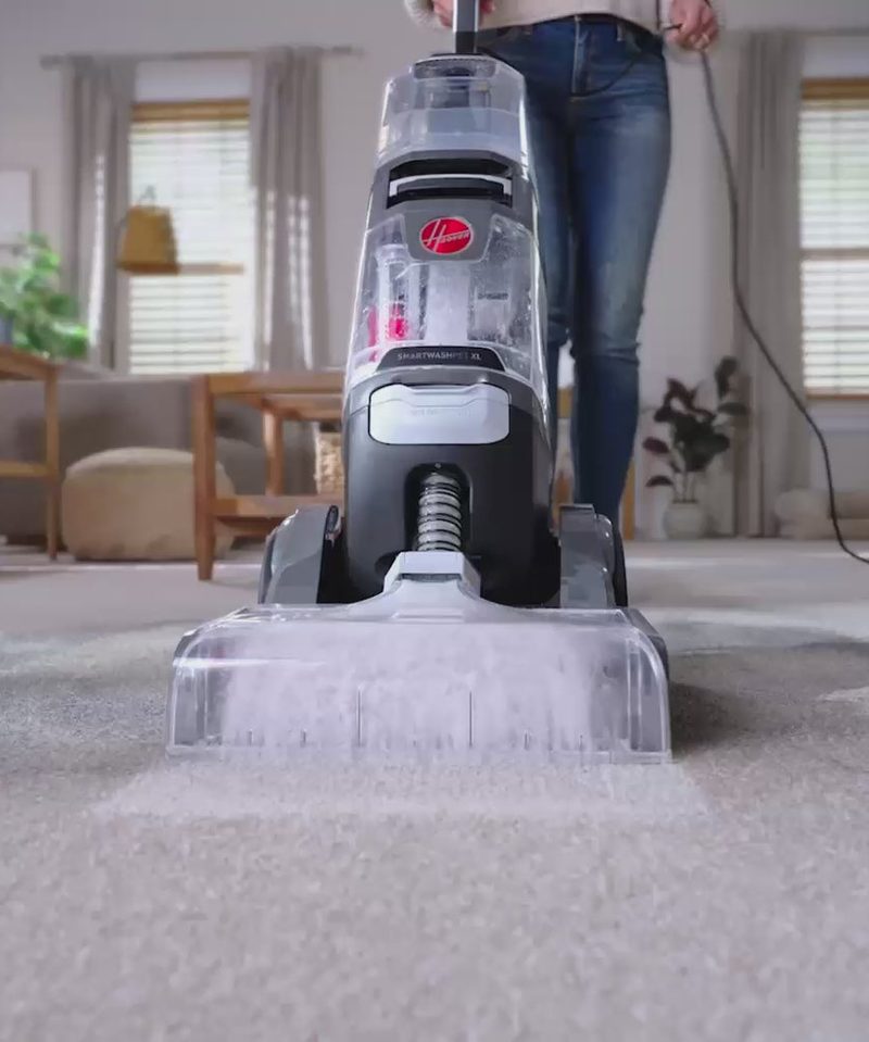 A Hoover carpet cleaner in use in a living room